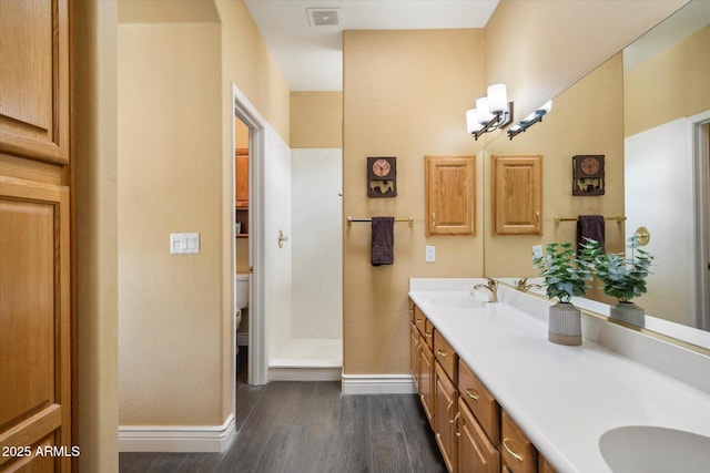 15225 E Golden Eagle Blvd, Fountain Hills, AZ 85268 - bathroom featuring wood finished floors, a sink, toilet, and visible vents