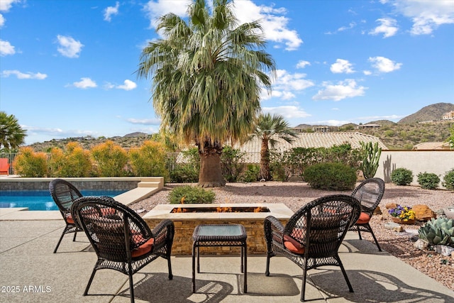 15225 E Golden Eagle Blvd, Fountain Hills, AZ 85268 - view of patio featuring a fenced in pool, fence, an outdoor fire pit, and a mountain view