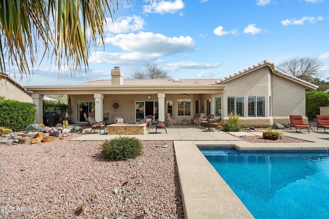 15225 E Golden Eagle Blvd, Fountain Hills, AZ 85268 - rear view of property with an outdoor fire pit, a chimney, stucco siding, and a patio area