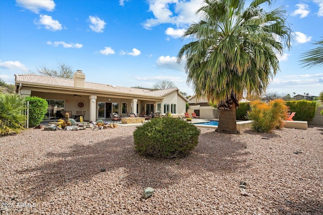 15225 E Golden Eagle Blvd, Fountain Hills, AZ 85268 - rear view of property with a patio area, a ceiling fan, a chimney, stucco siding, and a tiled roof