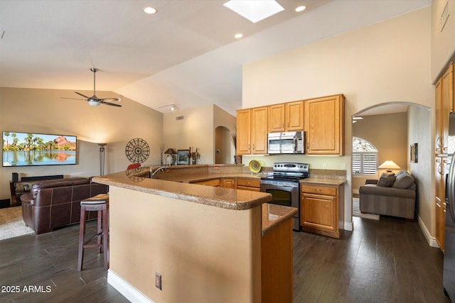 15225 E Golden Eagle Blvd, Fountain Hills, AZ 85268 - kitchen featuring open floor plan, arched walkways, ceiling fan, and appliances with stainless steel finishes