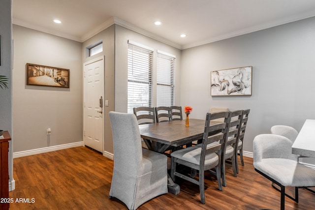 dining area with baseboards, ornamental molding, and wood finished floors