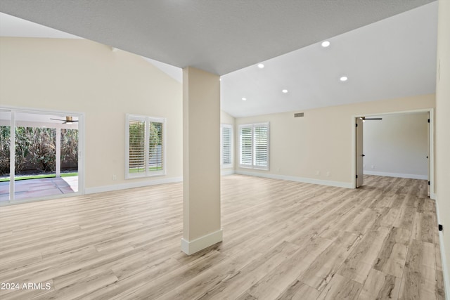 unfurnished living room with ceiling fan, light hardwood / wood-style floors, and high vaulted ceiling