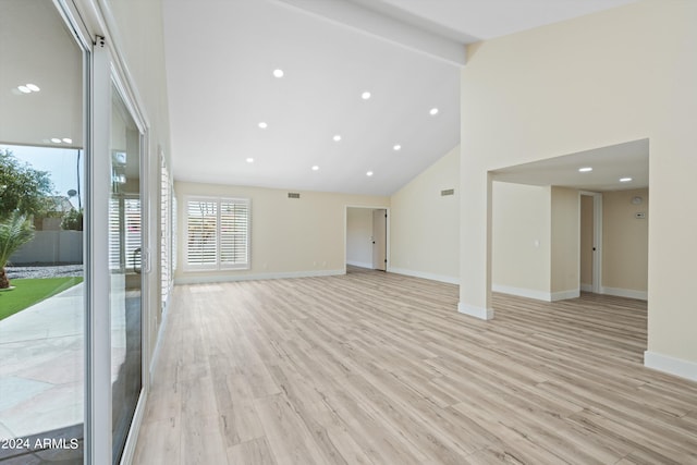 unfurnished living room featuring light hardwood / wood-style flooring and high vaulted ceiling