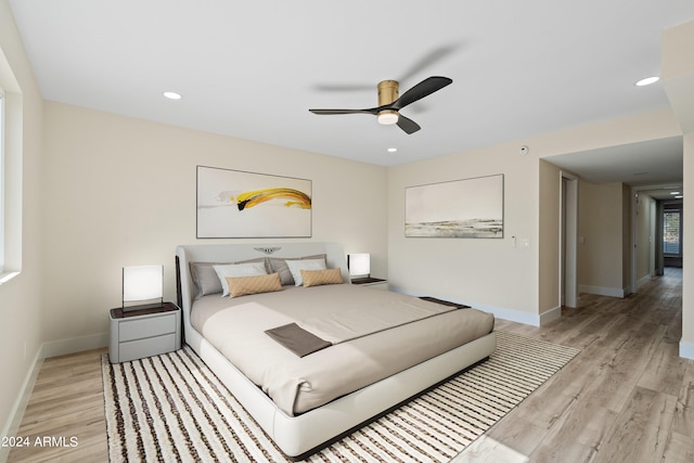 bedroom with light wood-type flooring and ceiling fan