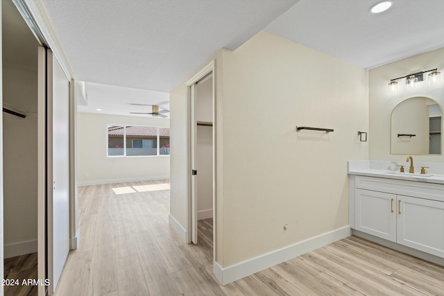 bathroom featuring vanity, hardwood / wood-style floors, and ceiling fan