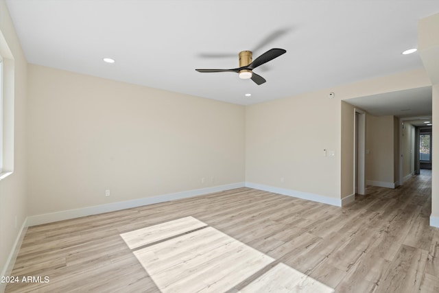 empty room featuring ceiling fan and light hardwood / wood-style floors