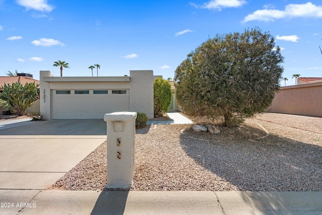 pueblo-style home featuring a garage