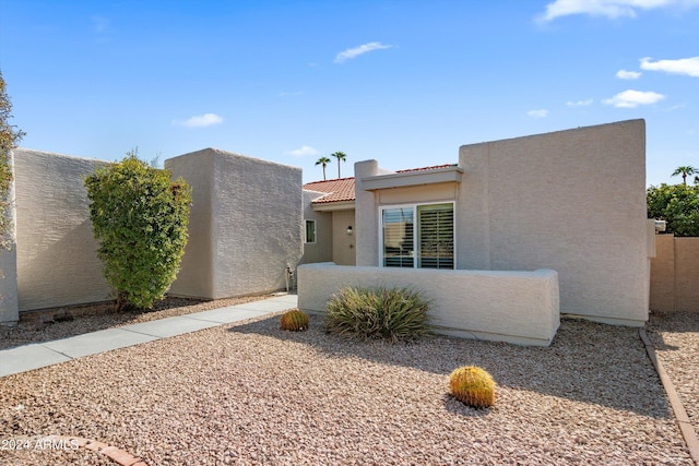 pueblo-style home featuring a patio