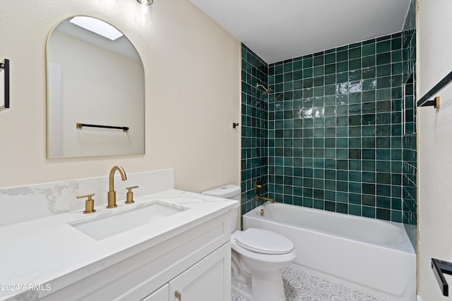 full bathroom featuring tiled shower / bath combo, vanity, and toilet