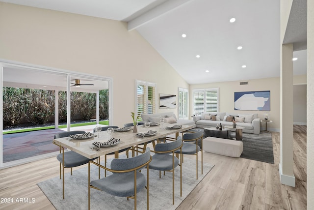 dining room featuring ceiling fan, light hardwood / wood-style flooring, beam ceiling, and high vaulted ceiling