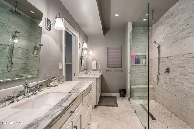 bathroom featuring tile patterned flooring, a shower with door, and vanity