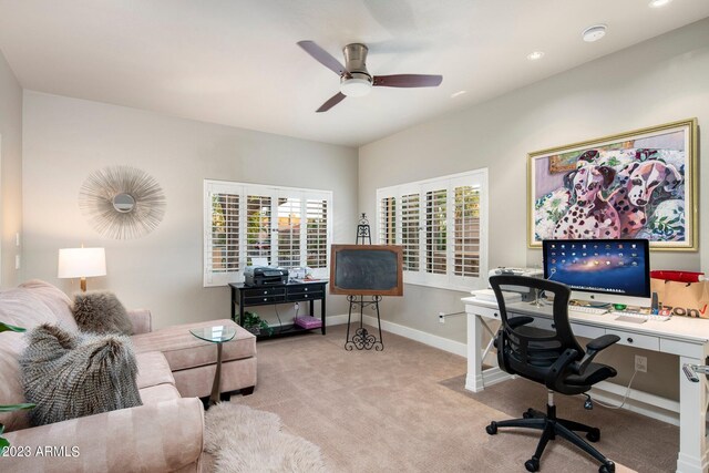 office space with ceiling fan and light carpet