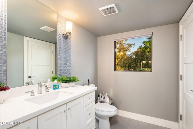 bathroom with vanity, toilet, and tile patterned flooring