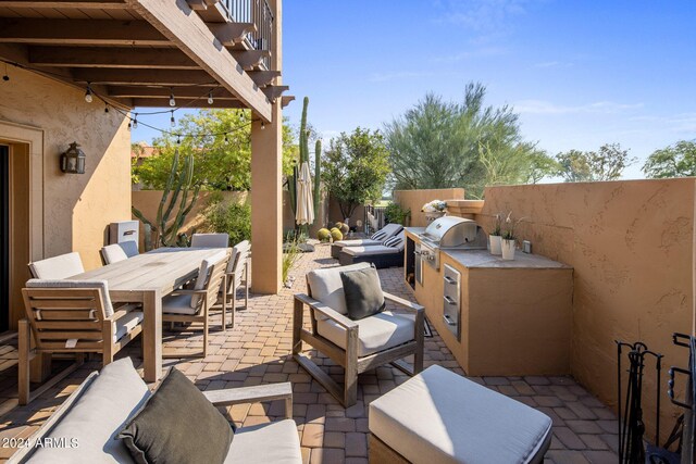 view of patio / terrace featuring grilling area and an outdoor kitchen