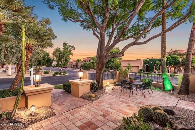 view of patio terrace at dusk