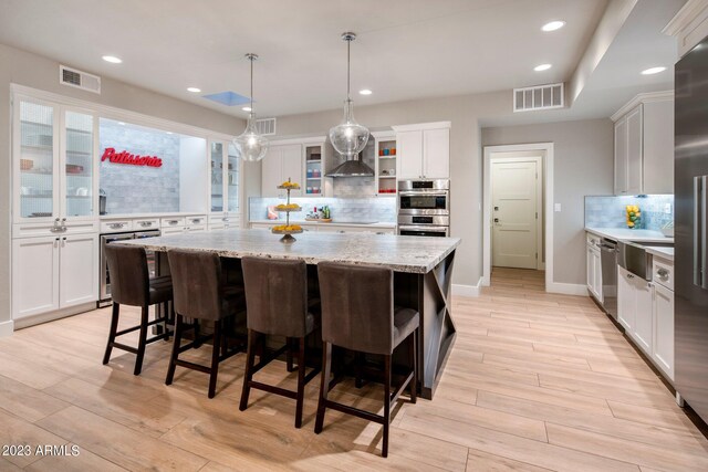 kitchen with a kitchen island and white cabinets