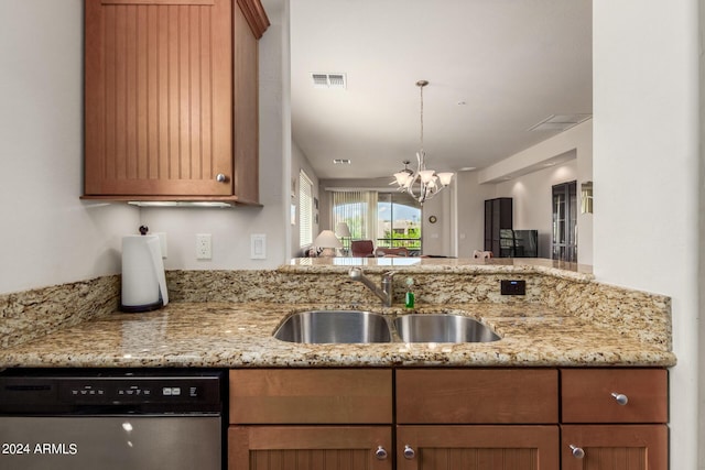 kitchen featuring light stone counters, stainless steel dishwasher, a notable chandelier, and sink