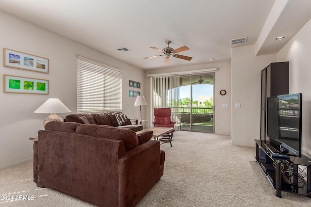 carpeted living room with ceiling fan