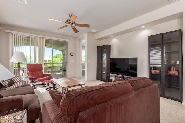 carpeted living room featuring ceiling fan