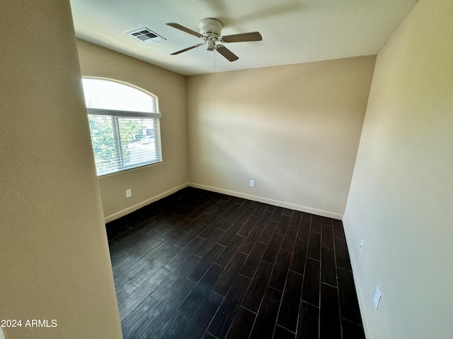 empty room featuring dark hardwood / wood-style floors and ceiling fan