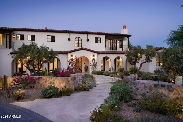 mediterranean / spanish-style house featuring a balcony