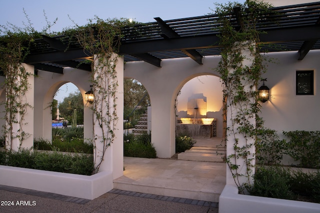 patio terrace at dusk with a pergola