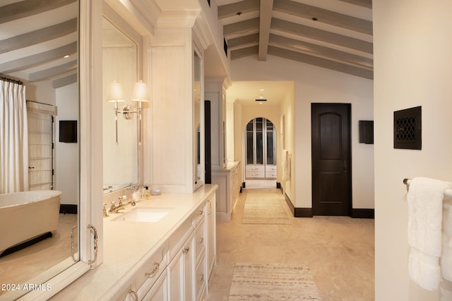 bathroom featuring vanity, vaulted ceiling with beams, and a bathtub