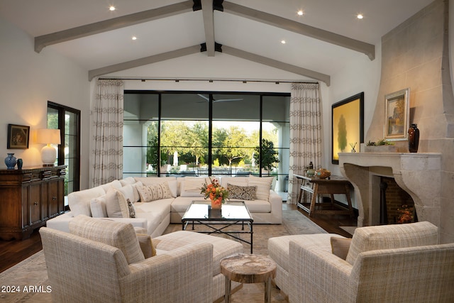 living room featuring hardwood / wood-style flooring, vaulted ceiling with beams, and a fireplace