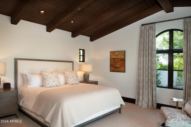 bedroom featuring lofted ceiling with beams, wooden ceiling, and carpet