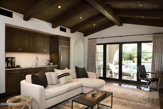 living room featuring wood ceiling, sink, and vaulted ceiling with beams