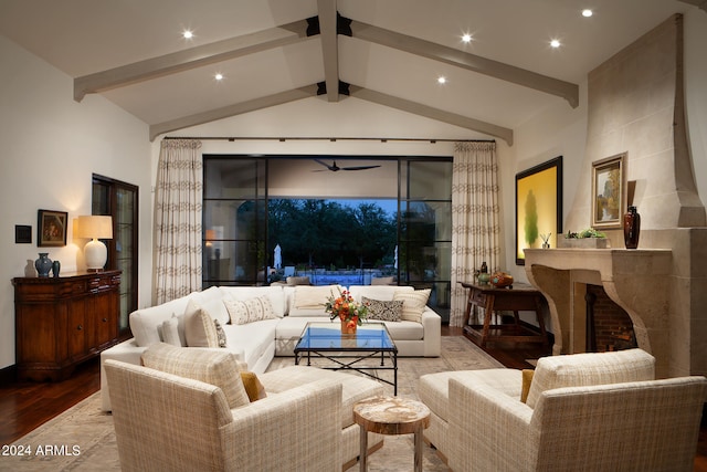 living room with a large fireplace, light hardwood / wood-style flooring, and vaulted ceiling with beams