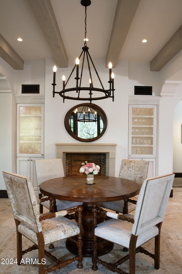 dining room with an inviting chandelier and beam ceiling