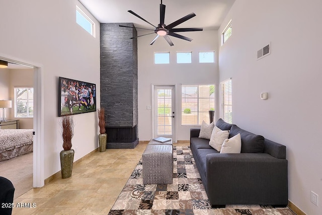 11333 N 92nd St Unit 1118, Scottsdale, AZ 85260 - living area featuring ceiling fan, a towering ceiling, and a stone fireplace
