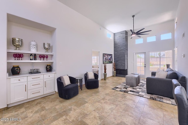 11333 N 92nd St Unit 1118, Scottsdale, AZ 85260 - living room featuring ceiling fan, stone tile floors, healthy amount of natural light, and a towering ceiling