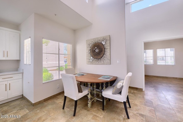11333 N 92nd St Unit 1118, Scottsdale, AZ 85260 - dining space featuring a high ceiling and light stone finish floors