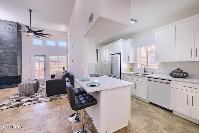 11333 N 92nd St Unit 1118, Scottsdale, AZ 85260 - kitchen featuring white appliances, ceiling fan, open floor plan, light countertops, and white cabinetry