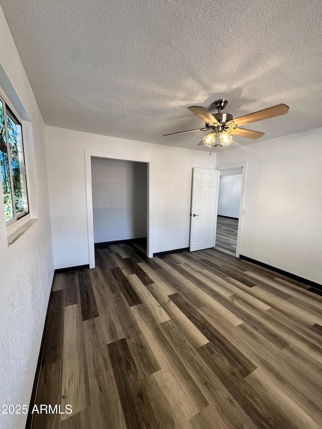 1214 E Henry St, Tempe, AZ 85288 - unfurnished bedroom featuring a textured ceiling, dark wood-style flooring, a closet, a ceiling fan, and baseboards