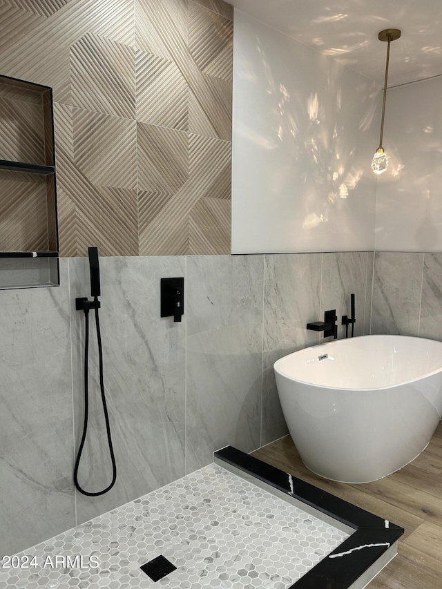 bathroom featuring tile walls and a bathtub