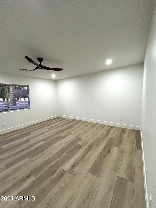 unfurnished room featuring ceiling fan and light hardwood / wood-style floors