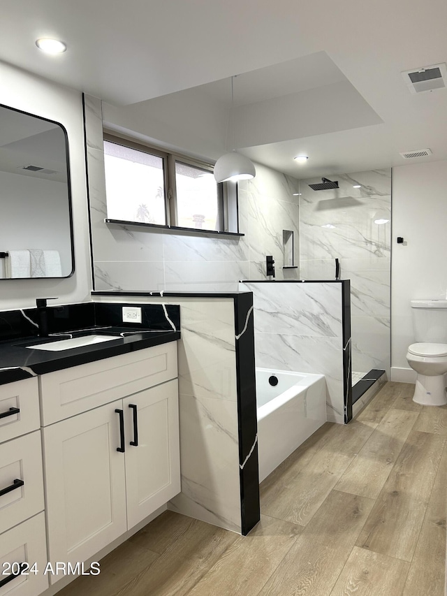 full bathroom with vanity, plus walk in shower, and toilet