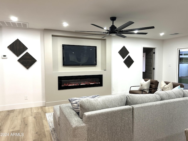 living room with light hardwood / wood-style floors and ceiling fan