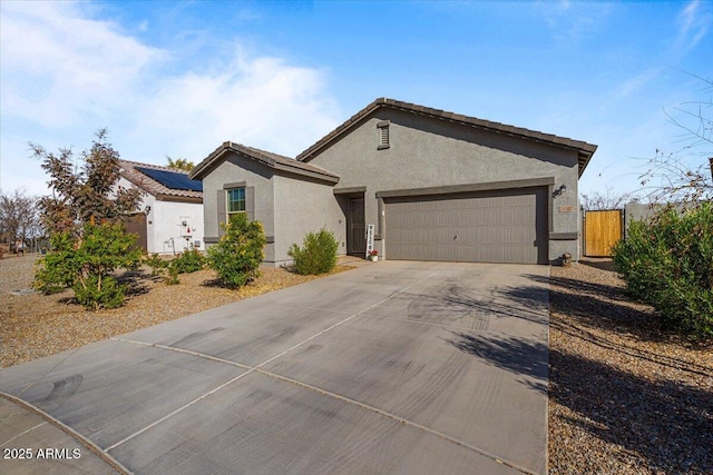 view of front of property with solar panels and a garage