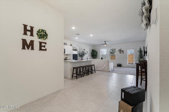 tiled living room featuring ceiling fan