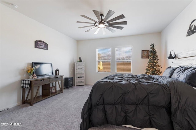 bedroom featuring ceiling fan and light carpet