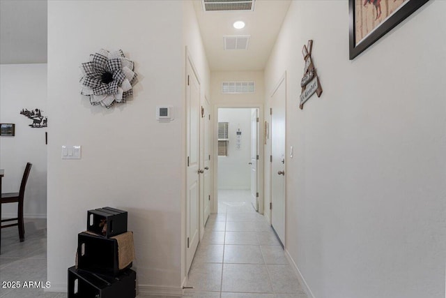 hall with light tile patterned floors