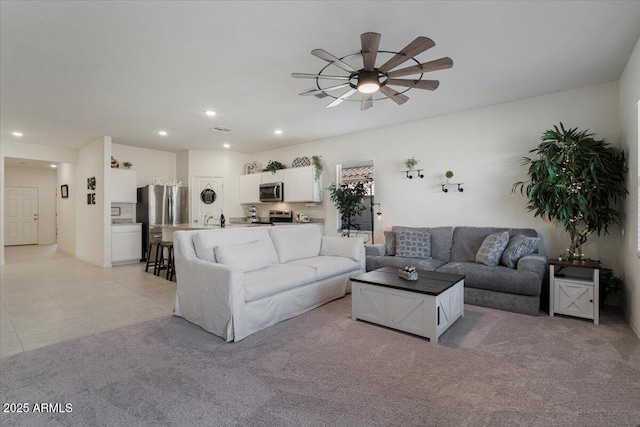 living room featuring ceiling fan and sink