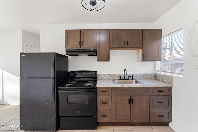 kitchen with light tile patterned flooring, sink, dark brown cabinets, light stone countertops, and black appliances