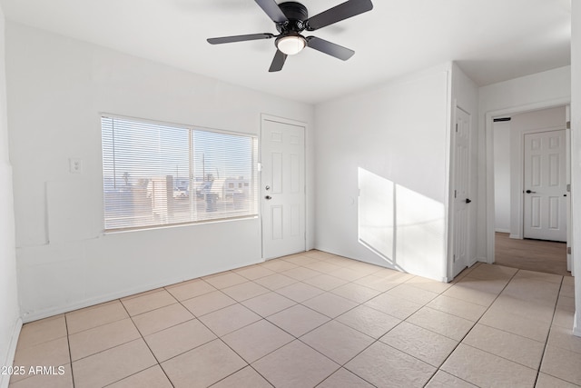 tiled empty room with ceiling fan