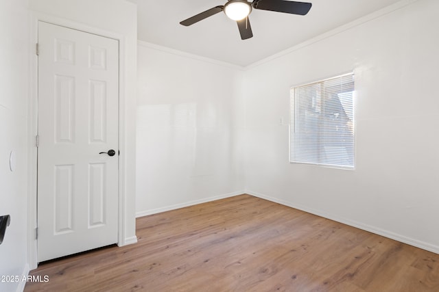 unfurnished room featuring ornamental molding, ceiling fan, and light hardwood / wood-style flooring